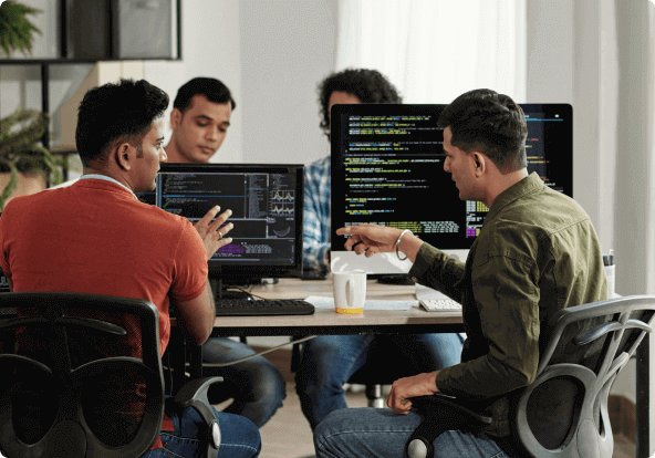 Two men eagerly discussing the code they wrote in office