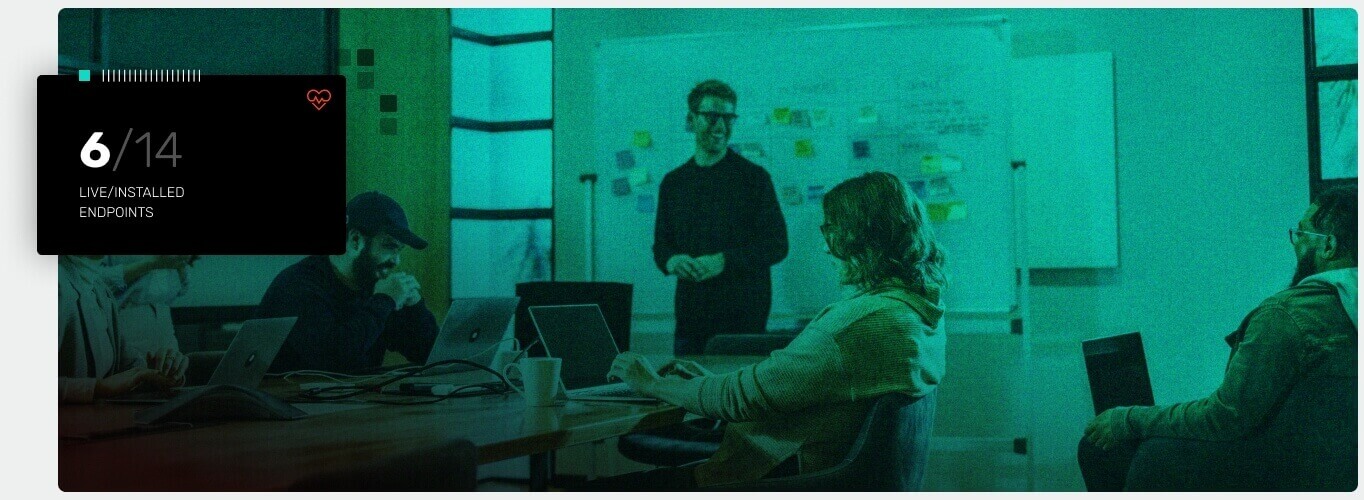 Cybersecurity team sitting together, collaborating in a conference room